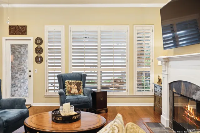 a living room with furniture fireplace and flat screen tv