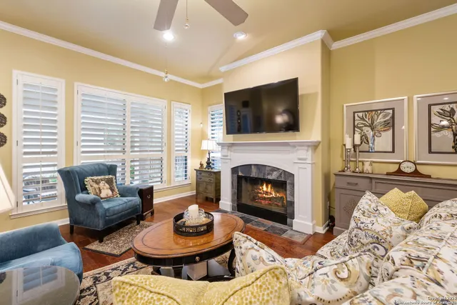 a dining room with furniture a chandelier and wooden floor