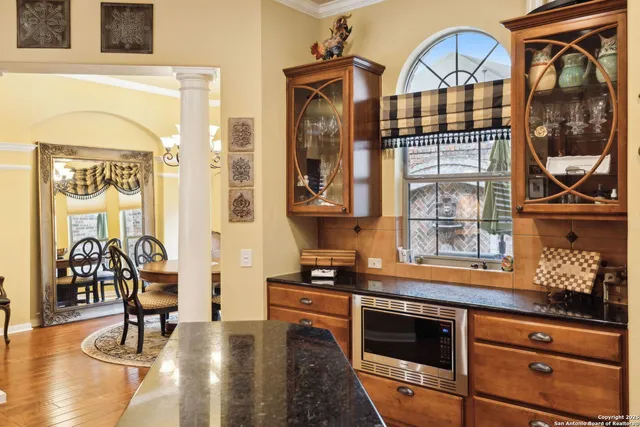a bathroom with a granite countertop double vanity sink and a mirror