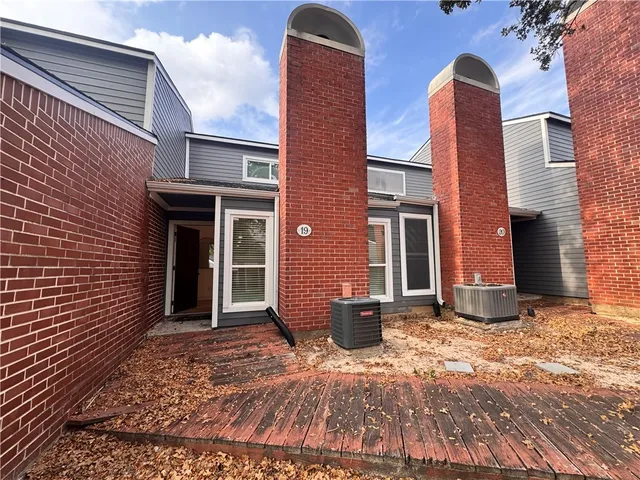 a view of a brick house with many windows