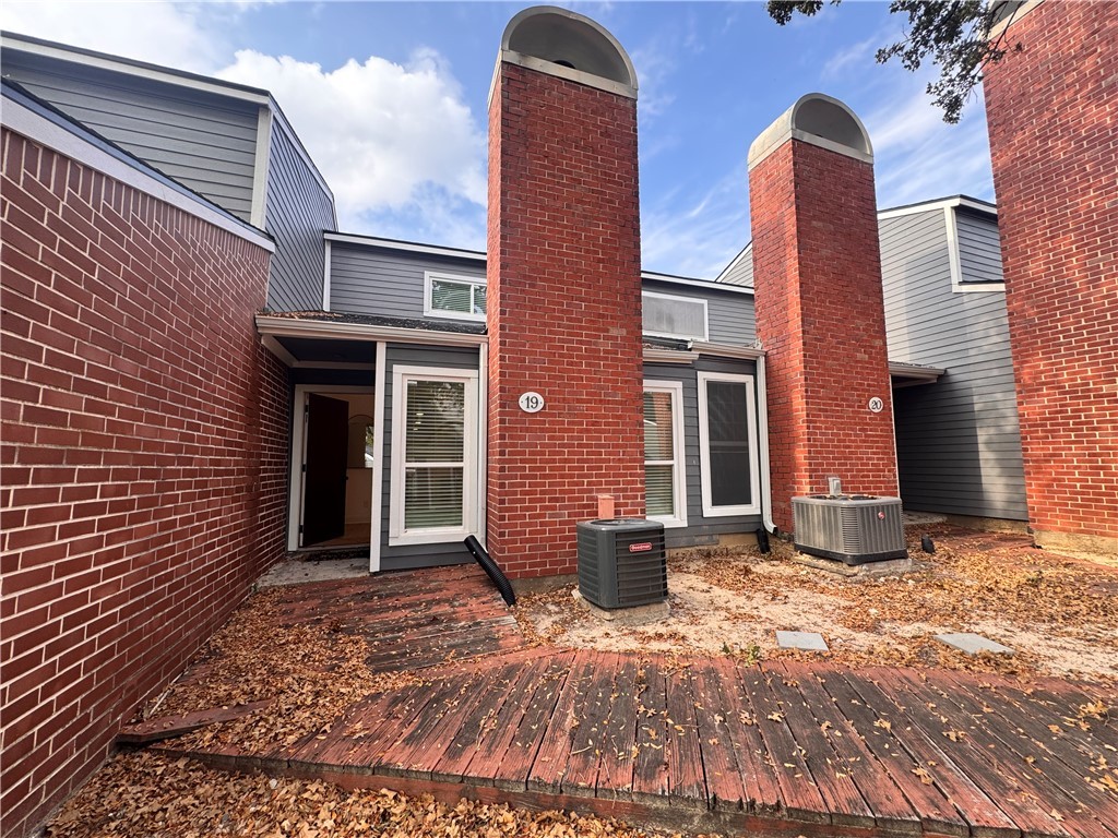 a view of a brick house with many windows