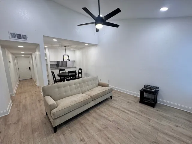 a living room with furniture and a wooden floor