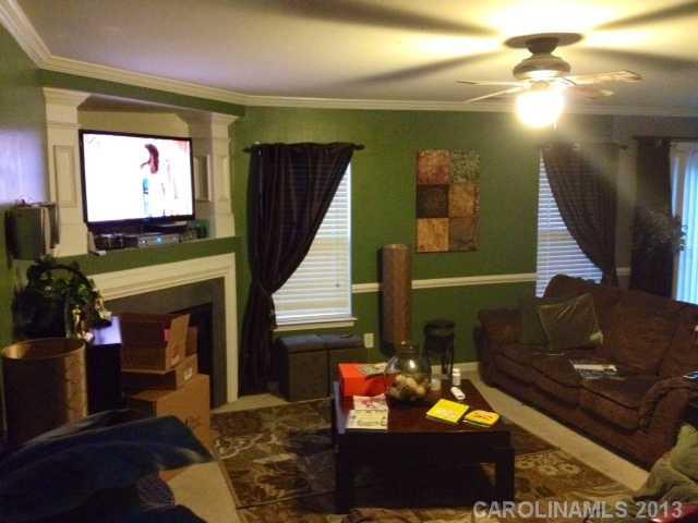 7139 Haines Mill Road Charlotte, NC 28273 - Photo 2 of 6 a living room with fireplace furniture and a flat screen tv