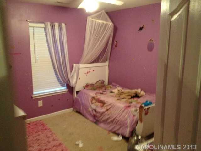 7139 Haines Mill Road Charlotte, NC 28273 - Photo 4 of 6 a bed sitting in a bedroom next to a window