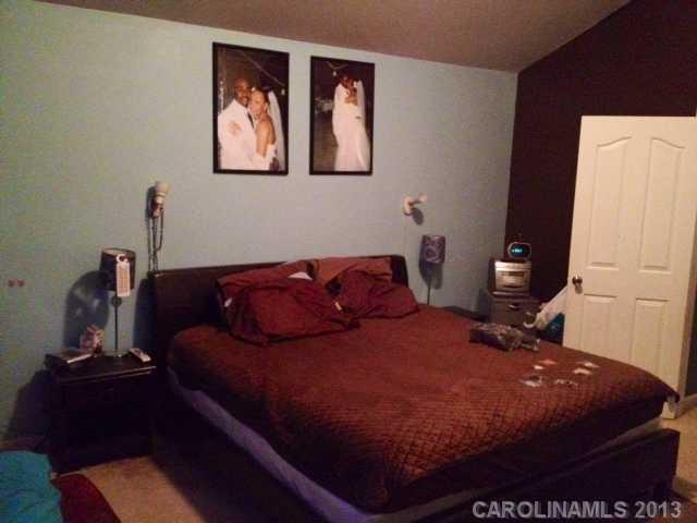 7139 Haines Mill Road Charlotte, NC 28273 - Photo 5 of 6 a bed sitting in a bedroom next to a window
