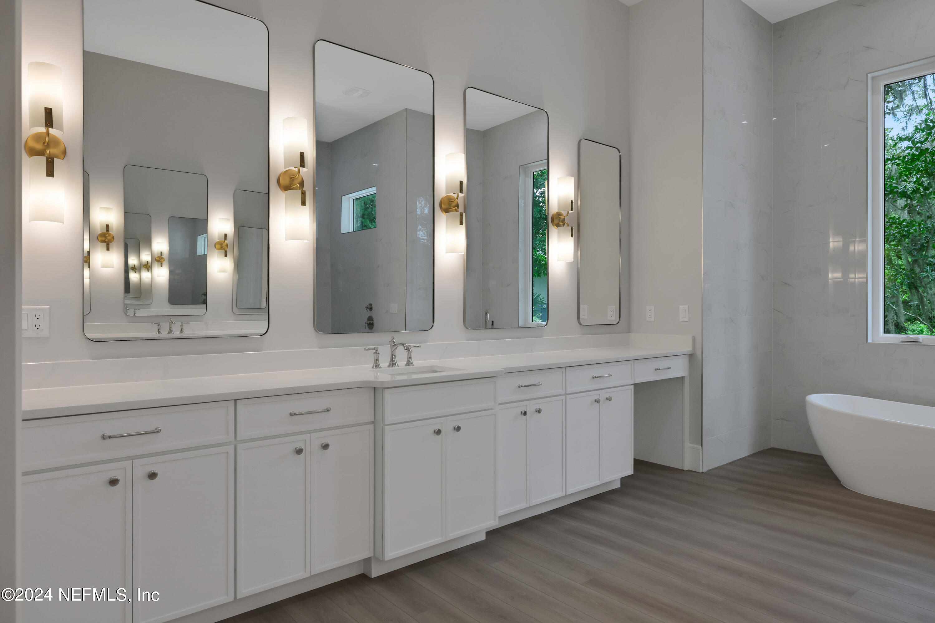 149 Marshall Creek Drive St. Augustine, FL 32095 - Photo 33 of 91 a spacious bathroom with double vanity a mirror and a bathtub