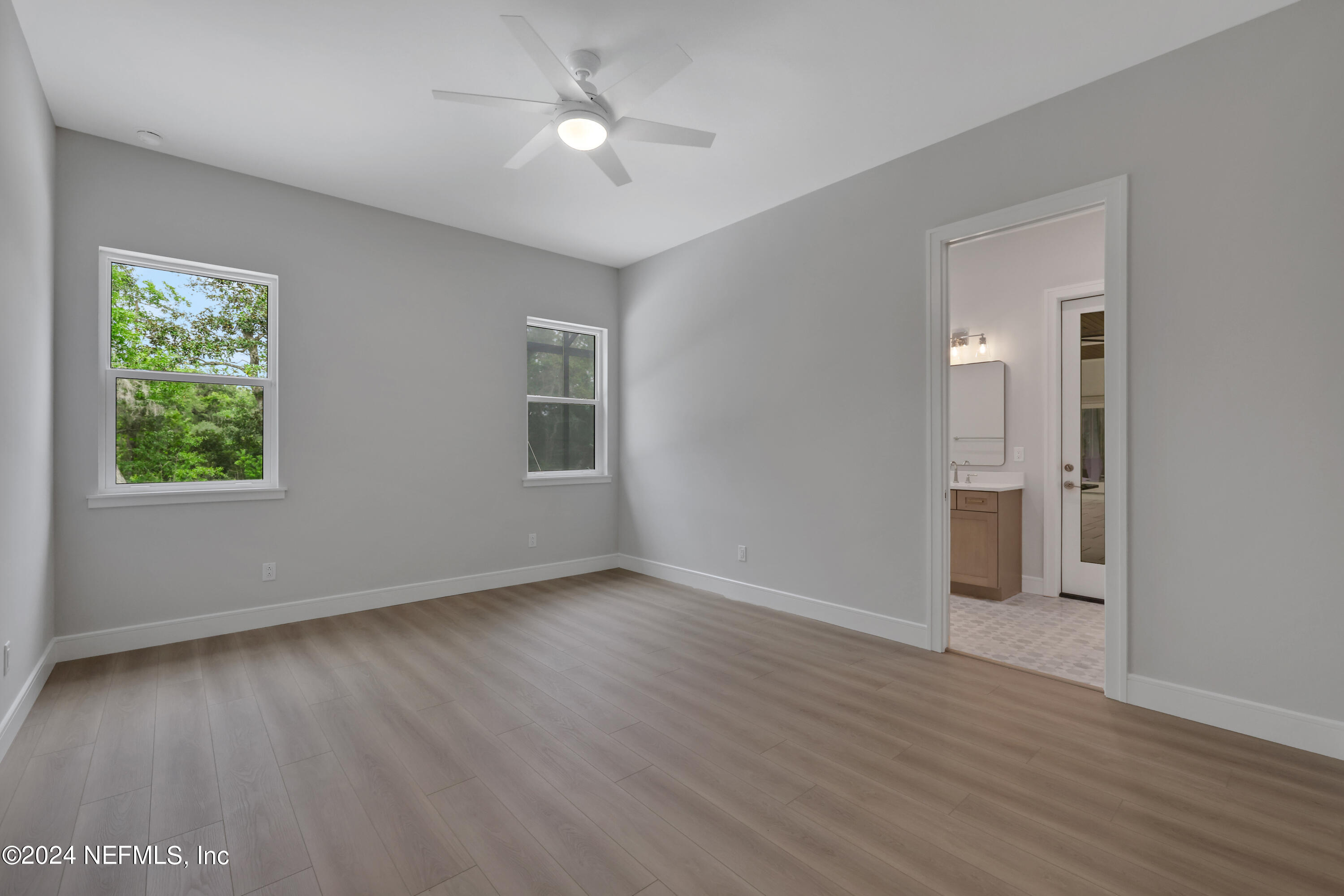 149 Marshall Creek Drive St. Augustine, FL 32095 - Photo 39 of 91 a view of an empty room with a window and wooden floor