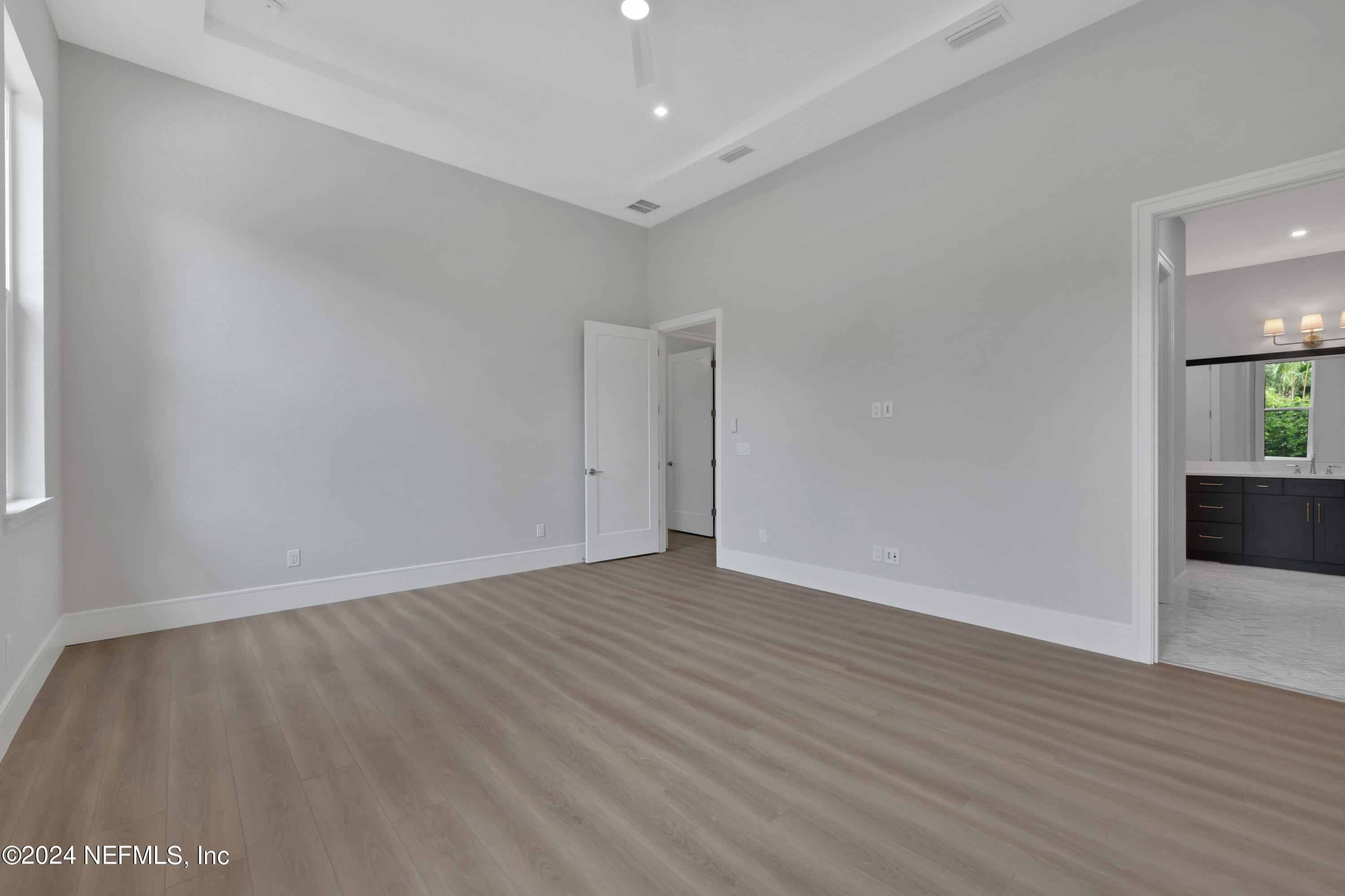 149 Marshall Creek Drive St. Augustine, FL 32095 - Photo 47 of 91 a view of an empty room with wooden floor and a window