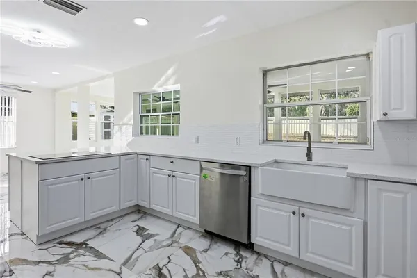 a kitchen that has a sink and a stove in it