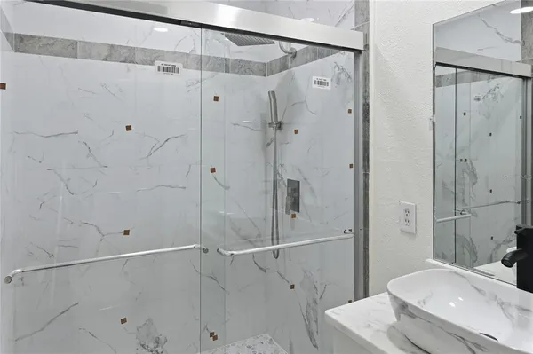 a bathroom with a shower and a sink