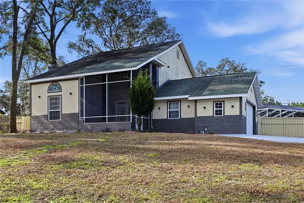 a front view of a house with a garden and yard