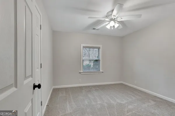 a bedroom with a bed and a potted plant