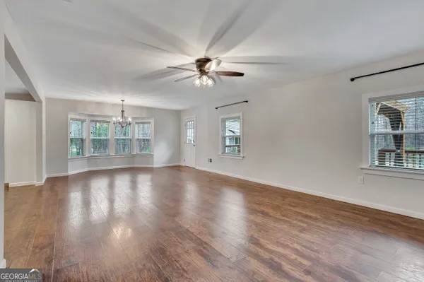 a view of an empty room with wooden floor
