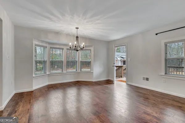 a kitchen with kitchen island granite countertop a sink a counter space stainless steel appliances and cabinets
