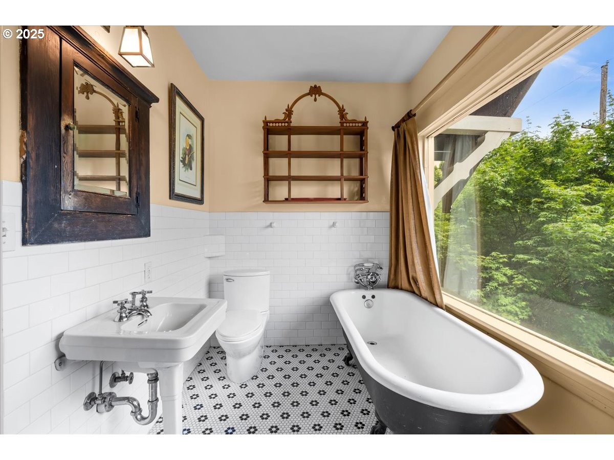 1844 Southeast 12th Avenue Portland, OR 97214 - Photo 21 of 48 a bathroom with a sink a toilet and a mirror