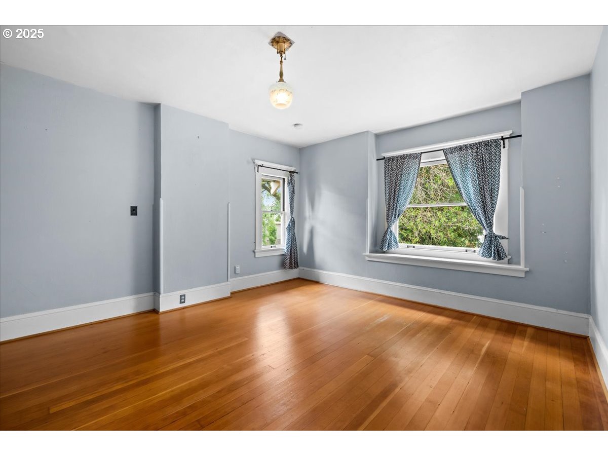 1844 Southeast 12th Avenue Portland, OR 97214 - Photo 24 of 48 an empty room with wooden floor and windows