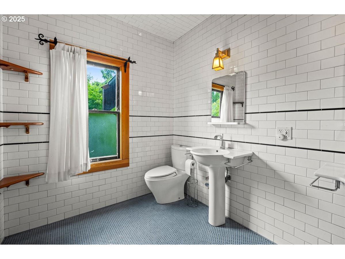1844 Southeast 12th Avenue Portland, OR 97214 - Photo 25 of 48 a bathroom with a toilet sink and mirror