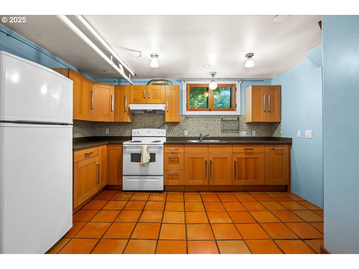 1844 Southeast 12th Avenue Portland, OR 97214 - Photo 37 of 48 a kitchen with a sink a stove top oven and cabinets