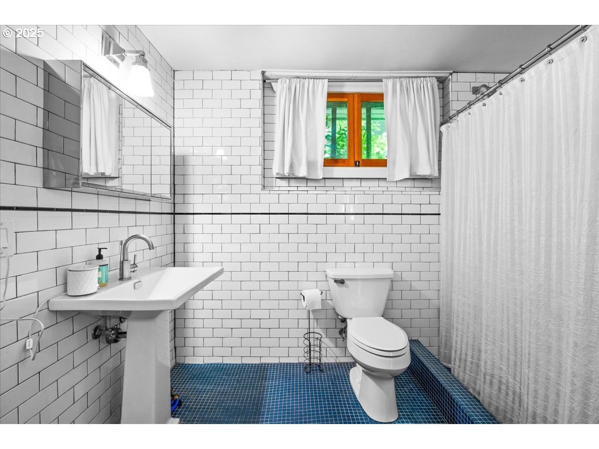 1844 Southeast 12th Avenue Portland, OR 97214 - Photo 39 of 48 a bathroom with a sink a toilet and a mirror