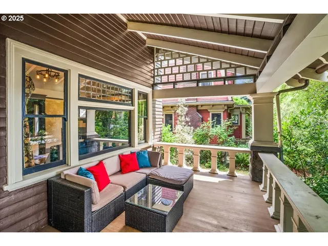 a living room with couch and floor to ceiling windows