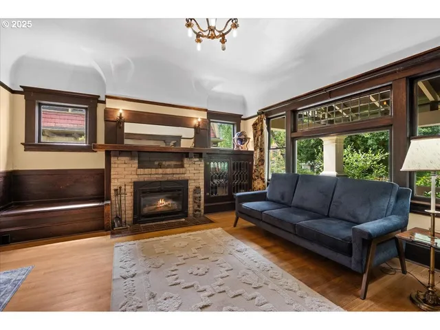a living room with furniture a window and a fireplace