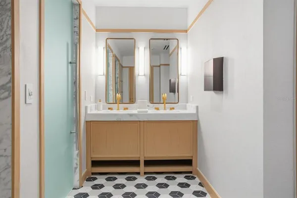 a kitchen with stainless steel appliances granite countertop a sink and a refrigerator