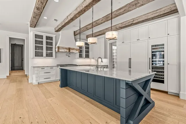 a living room with furniture a flat screen tv and a large window