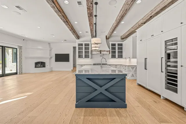 a kitchen with a sink a stove and cabinets