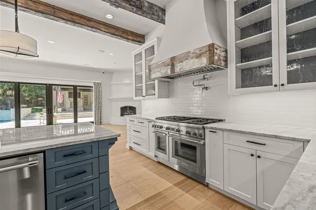 a view of patio with a table and chairs under an umbrella with a fire pit