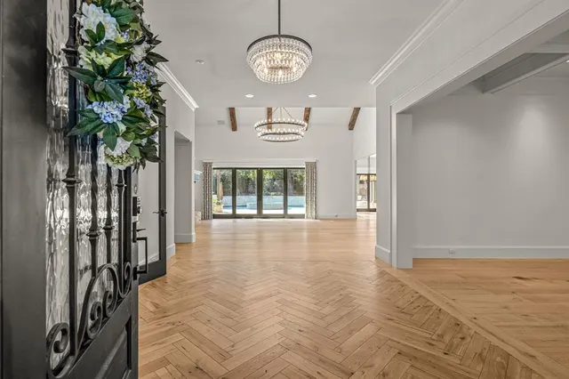 a view of a livingroom with furniture wooden floor and a chandelier