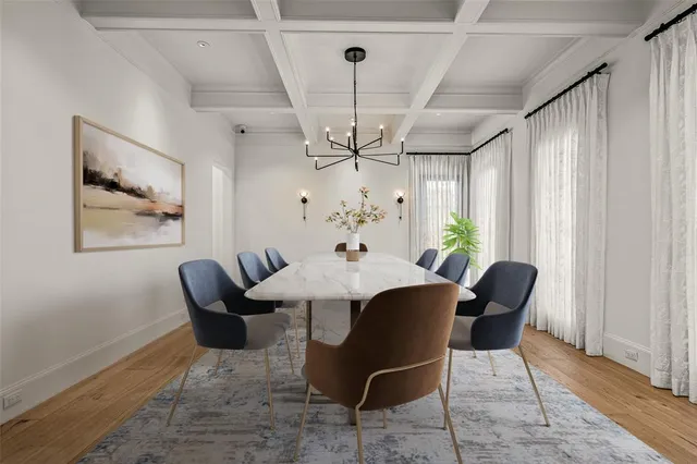 a living room with furniture a fireplace and a large window