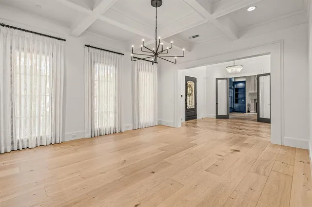 a living room with furniture kitchen and a chandelier