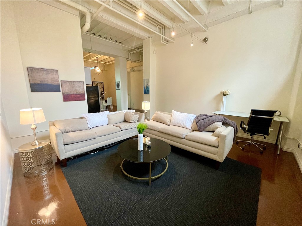 312 West 5th Street, Unit 701 Los Angeles, CA 90013 - Photo 12 of 15 a living room with furniture rug and lamp