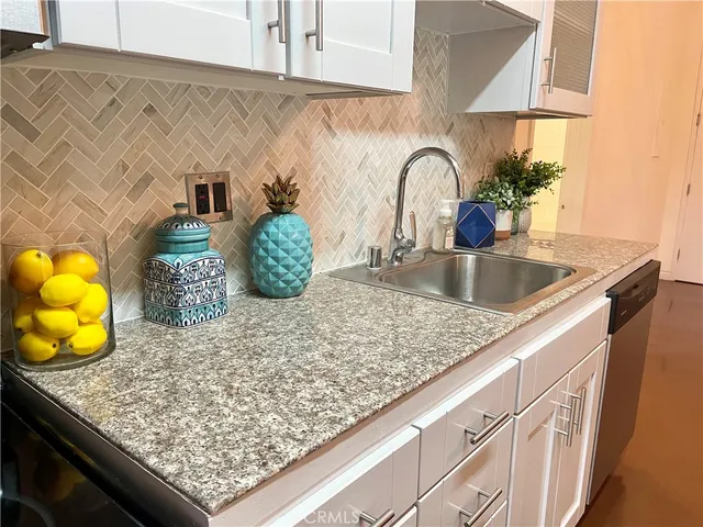 a kitchen with kitchen island a counter top and stove