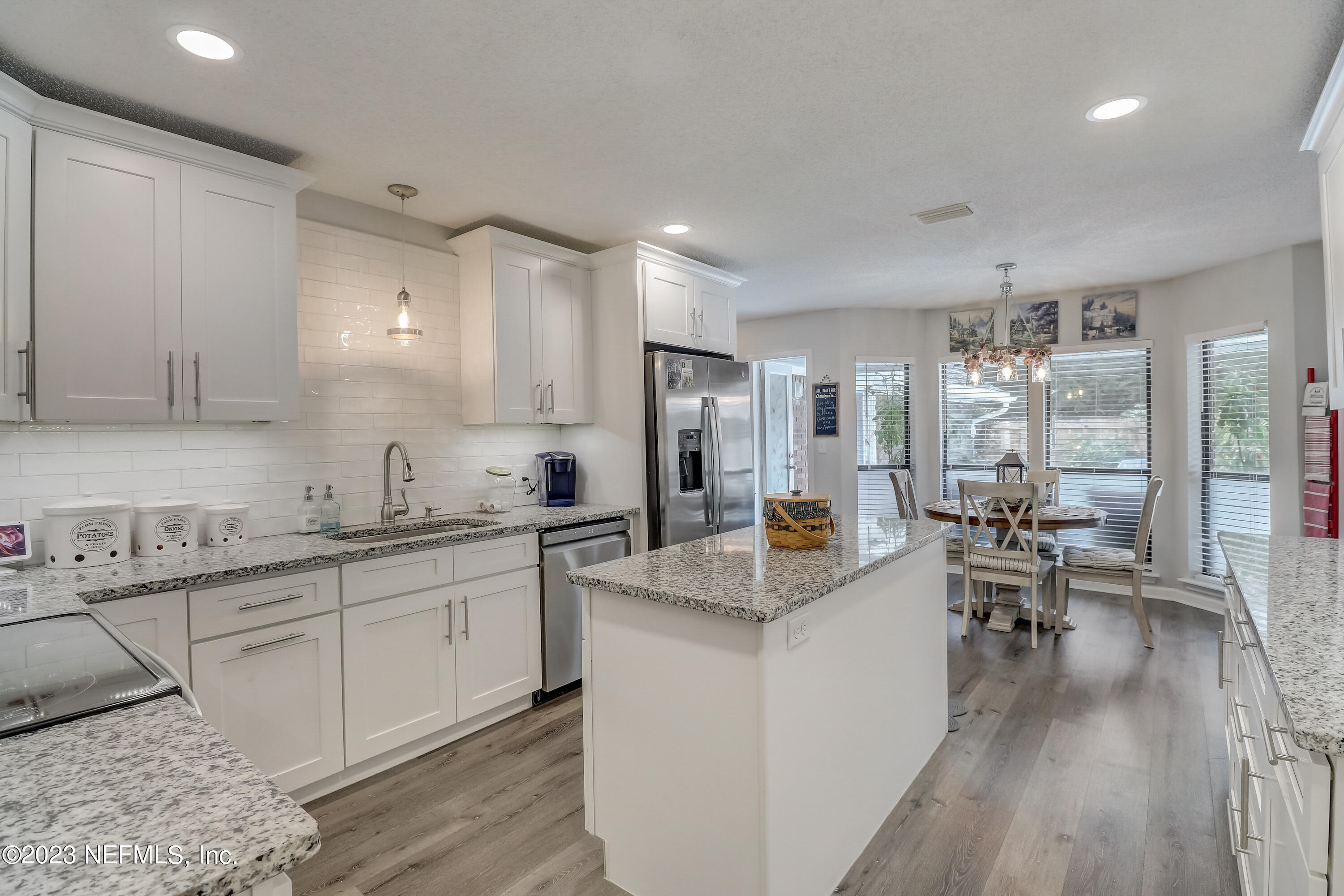55377 Deer Run Road Callahan, FL 32011 - Photo 13 of 47 a large kitchen with sink cabinets and wooden floor