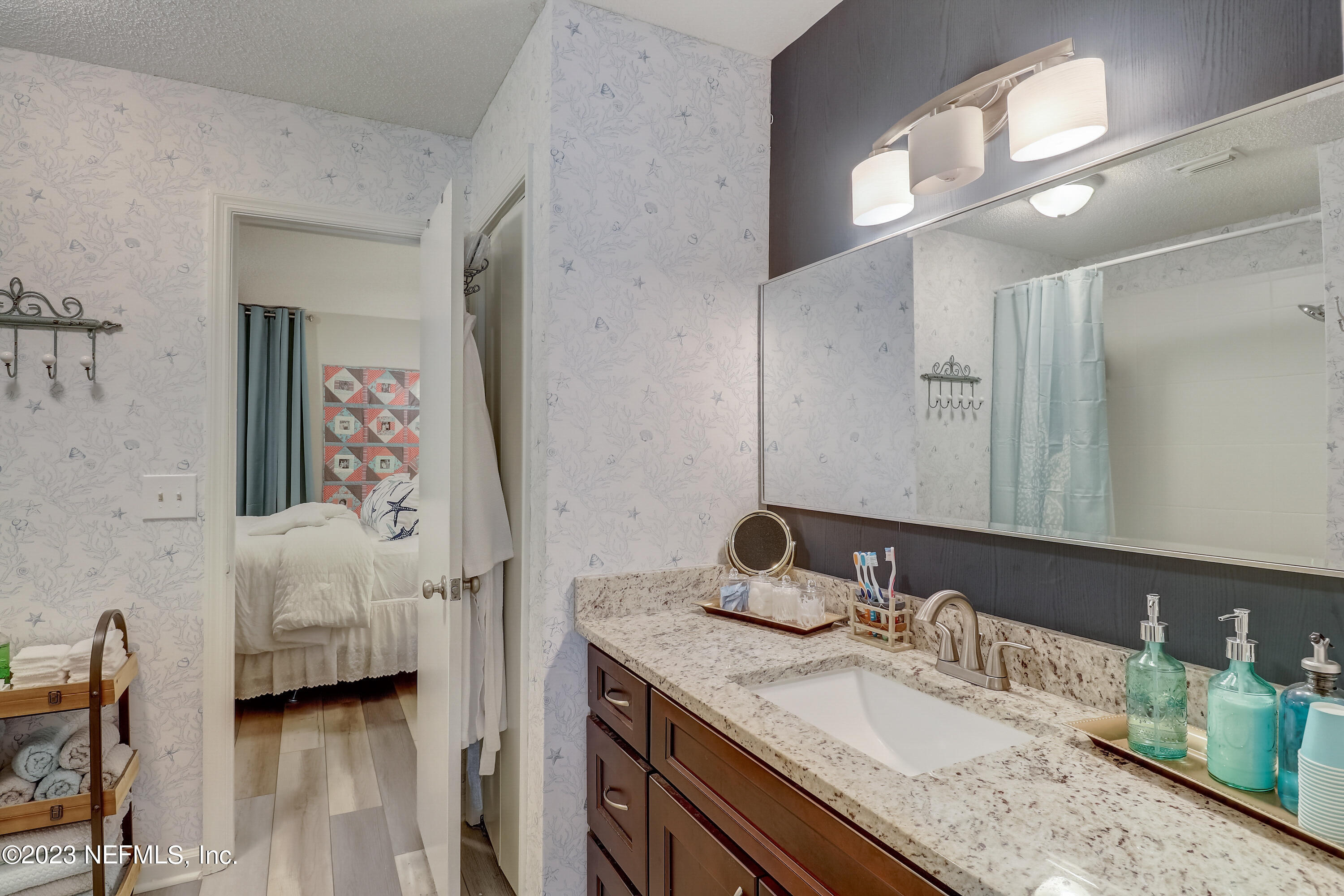 55377 Deer Run Road Callahan, FL 32011 - Photo 16 of 47 a en suite bathroom with a granite countertop sink and a mirror