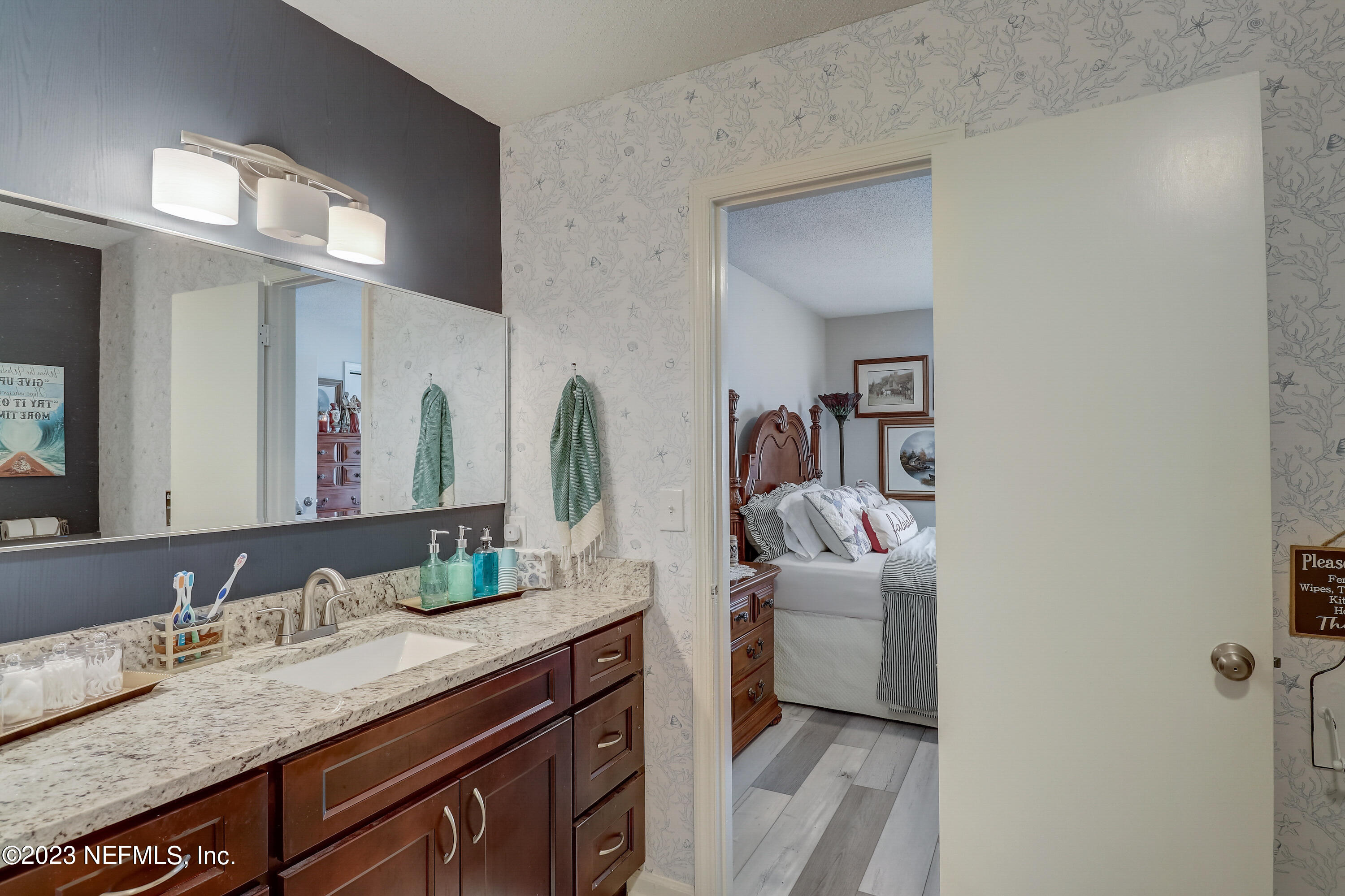 55377 Deer Run Road Callahan, FL 32011 - Photo 18 of 47 a en suite bathroom with a granite countertop sink and a mirror