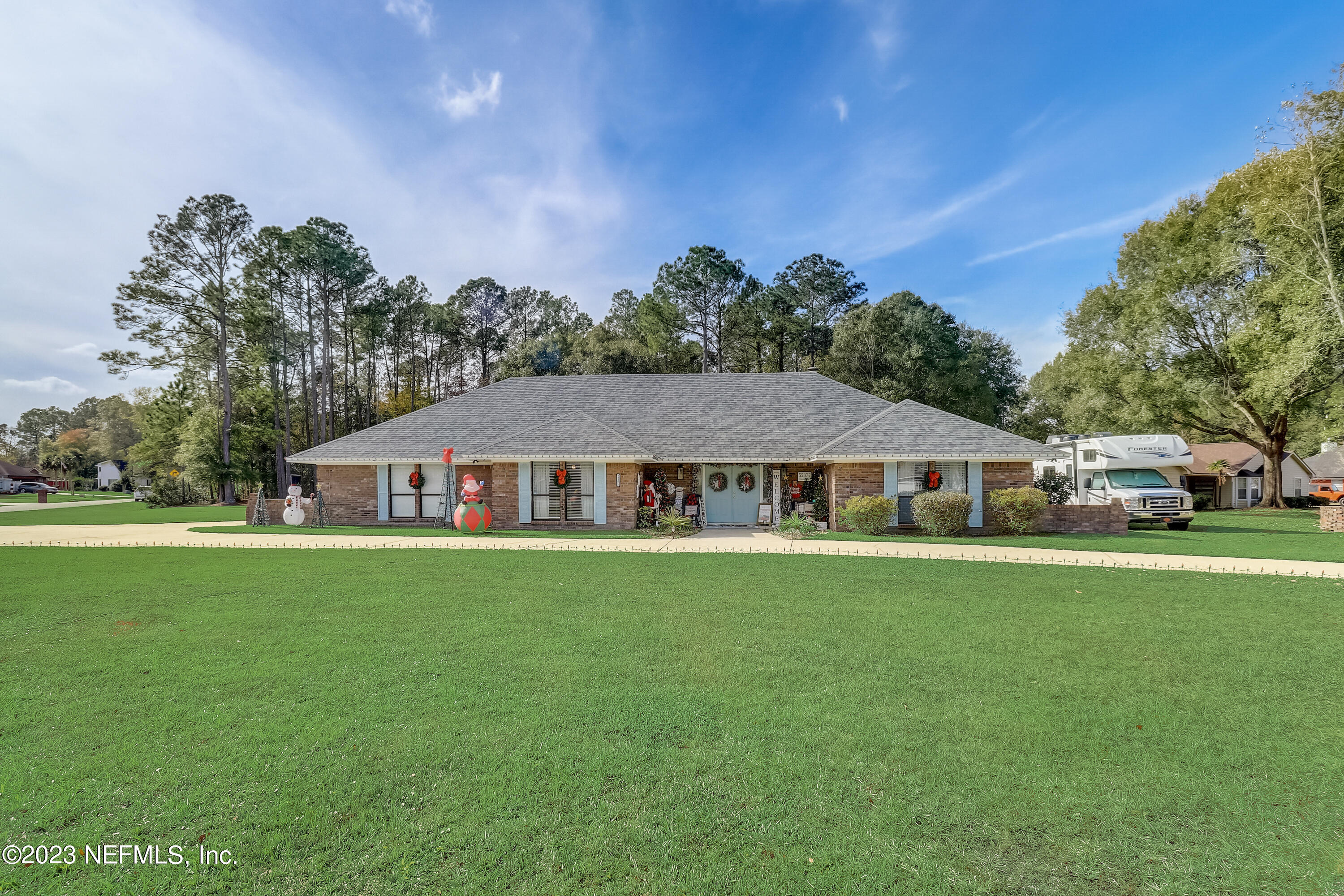 55377 Deer Run Road Callahan, FL 32011 - Photo 3 of 47 a front view of a house with a garden