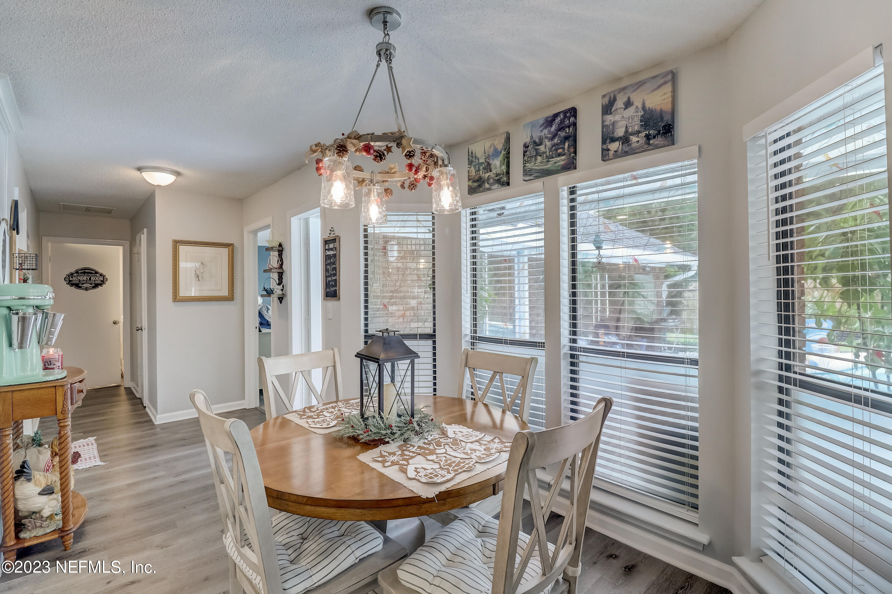 55377 Deer Run Road Callahan, FL 32011 - Photo 10 of 47 a view of a dining room with furniture wooden floor and chandelier