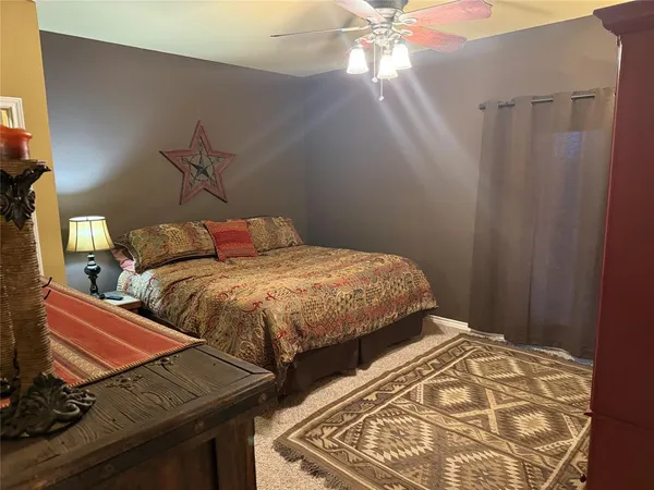a bedroom with two beds and a chandelier