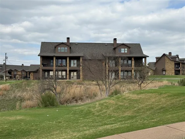 a front view of house with a garden