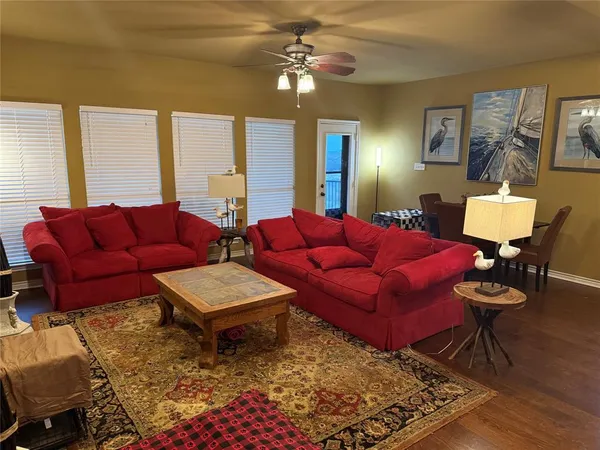 a living room with furniture ceiling fan and a rug
