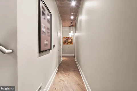 a view of a hallway with wooden floor