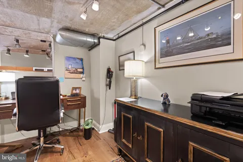 a view of a workspace with furniture and gym equipment