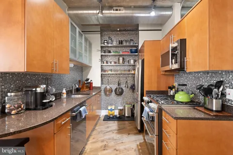 a kitchen with refrigerator and cabinets