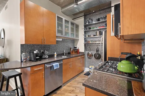 a kitchen with stainless steel appliances granite countertop a stove and a sink