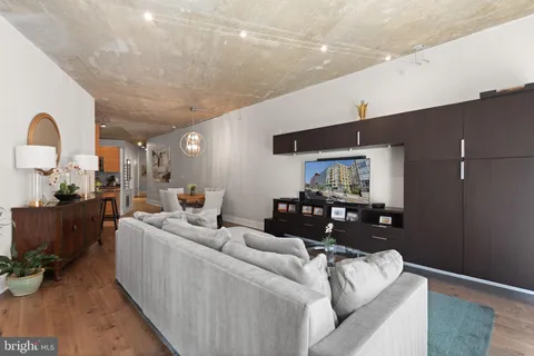 a living room with furniture and a wooden floor