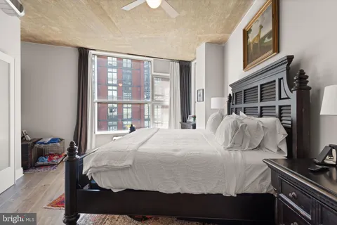 a bedroom with a bed and wooden floor