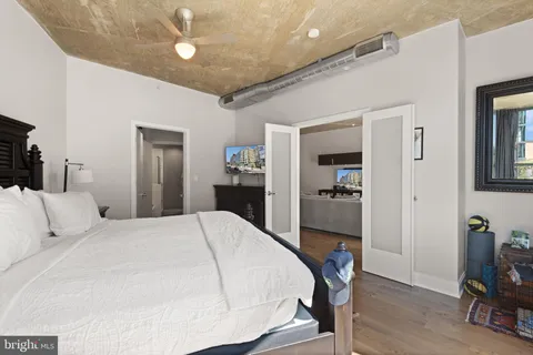 a bedroom with a bed and a chandelier