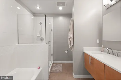 a bathroom with a shower and a tub